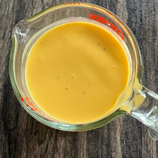mango 3 milk mixture in a glass jug