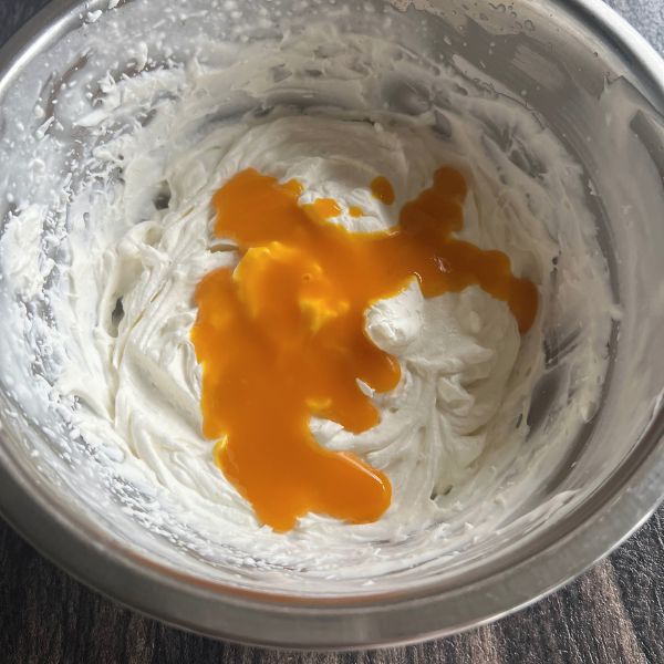 mango puree added to the whipped cream